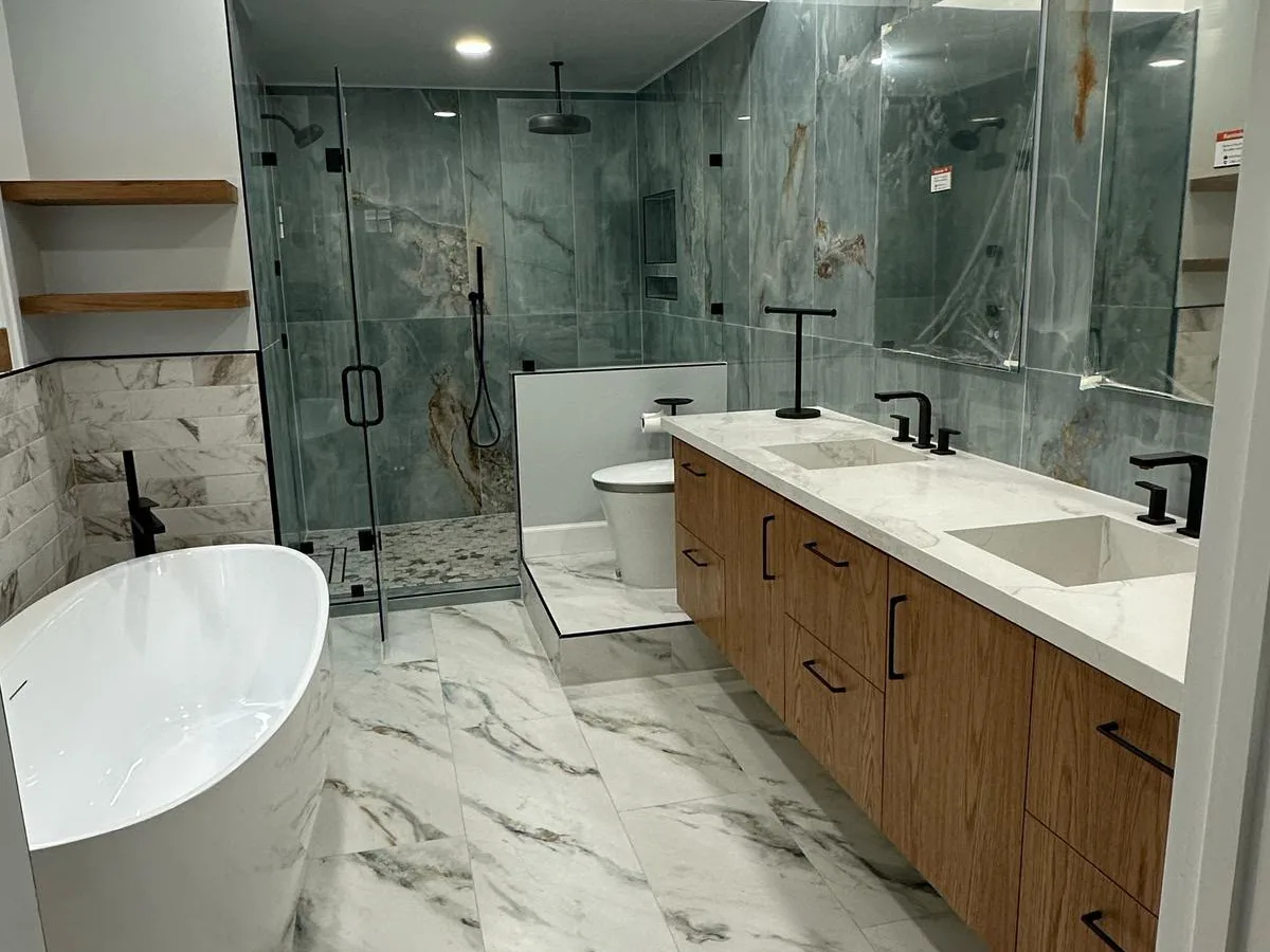 Bathroom with a double vanity, freestanding tub and tiled shower