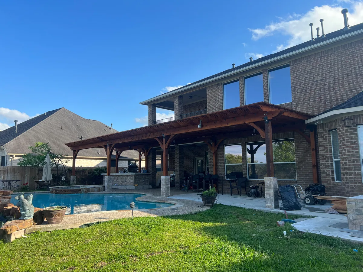 Cedar pergola over a backyard pool, finished
