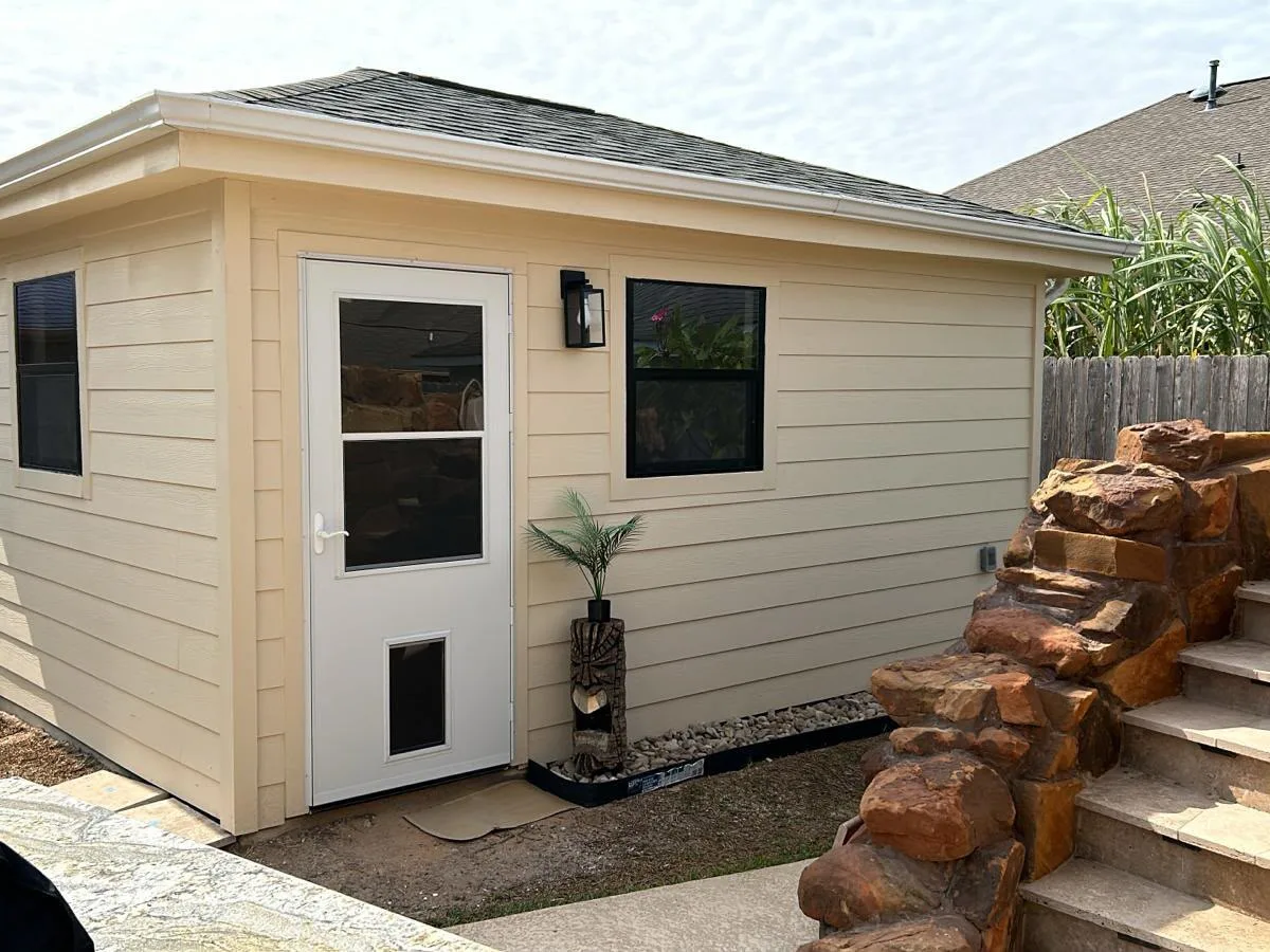 Backyard shed with siding, a window and a door